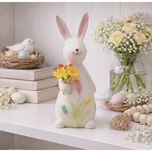 Figur kanin holder gul blomst påske